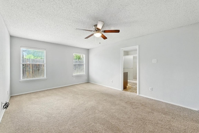 4614 Ganymede Dr, Austin, TX 78727 - unfurnished room featuring carpet floors, a ceiling fan, and a textured ceiling