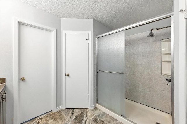 4614 Ganymede Dr, Austin, TX 78727 - full bath featuring a stall shower, vanity, and a textured ceiling
