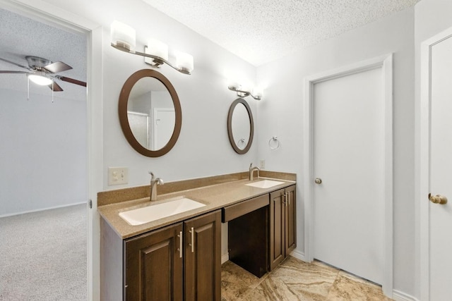 4614 Ganymede Dr, Austin, TX 78727 - full bathroom featuring a textured ceiling, a ceiling fan, and double vanity