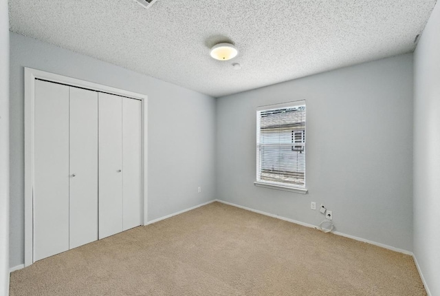 4614 Ganymede Dr, Austin, TX 78727 - unfurnished bedroom with carpet flooring, a closet, and a textured ceiling