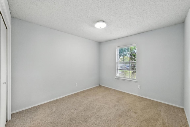4614 Ganymede Dr, Austin, TX 78727 - carpeted spare room with baseboards and a textured ceiling