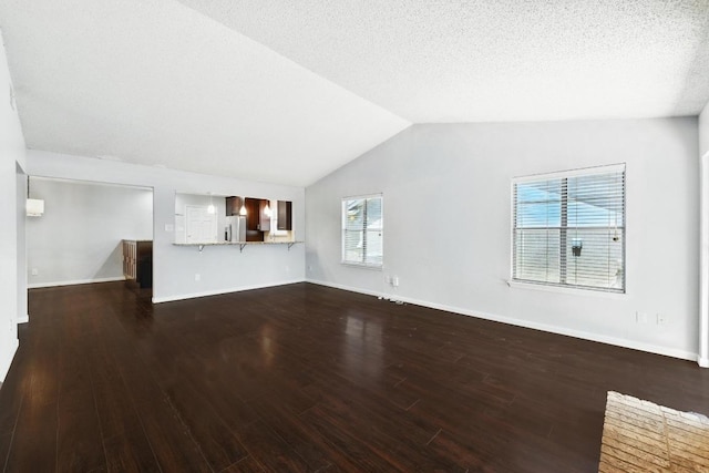 4614 Ganymede Dr, Austin, TX 78727 - unfurnished living room featuring wood finished floors, vaulted ceiling, and a textured ceiling