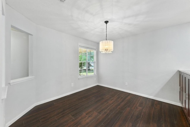 4614 Ganymede Dr, Austin, TX 78727 - unfurnished room featuring dark wood-type flooring and a chandelier