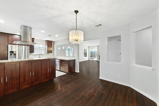 4614 Ganymede Dr, Austin, TX 78727 - kitchen with appliances with stainless steel finishes, island range hood, dark wood finished floors, a chandelier, and hanging light fixtures