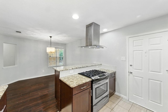 4614 Ganymede Dr, Austin, TX 78727 - kitchen featuring stainless steel range with gas stovetop, island range hood, a peninsula, a chandelier, and light stone countertops