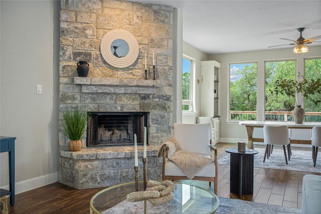 1621 Angolo, New Braunfels, TX 78132 - living area with wood finished floors, a ceiling fan, and a stone fireplace