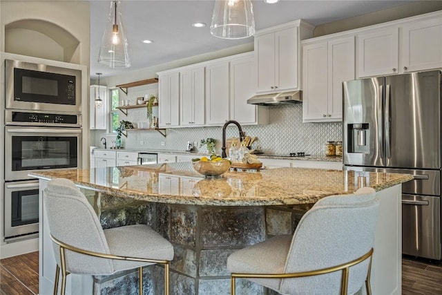 1621 Angolo, New Braunfels, TX 78132 - kitchen with appliances with stainless steel finishes, under cabinet range hood, white cabinetry, dark wood-style floors, and recessed lighting
