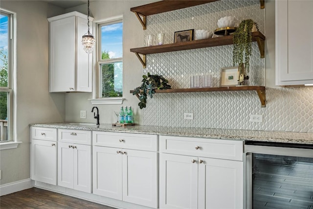 1621 Angolo, New Braunfels, TX 78132 - kitchen with wine cooler, open shelves, decorative backsplash, and white cabinets