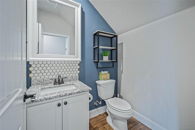 1621 Angolo, New Braunfels, TX 78132 - bathroom featuring lofted ceiling, wood finished floors, vanity, and a textured ceiling