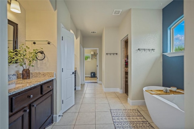 1621 Angolo, New Braunfels, TX 78132 - full bath featuring vanity, a freestanding tub, and tile patterned floors