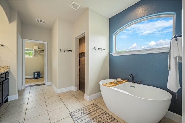 1621 Angolo, New Braunfels, TX 78132 - bathroom with vanity, a freestanding bath, tile patterned floors, and tiled shower