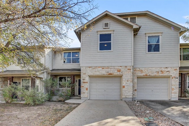 512 Eberhart Ln Unit 1207, Austin, TX 78745 - view of front of property featuring driveway, stone siding, and an attached garage