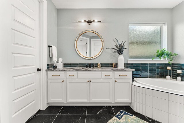 518 Toyah Dr, Dripping Springs, TX 78620 - bathroom with vanity, a bath, and marble finish flooring