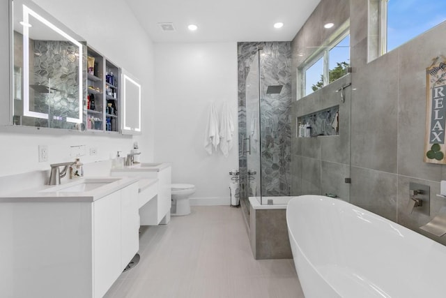 123 Zacate St, Elgin, TX 78621 - bathroom featuring a freestanding bath, a shower stall, vanity, and recessed lighting