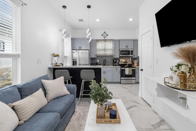 123 Zacate St, Elgin, TX 78621 - living area with recessed lighting and light marble finish floors