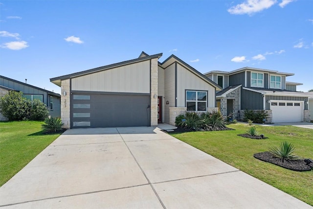 253 Centuryplant Rd, Leander, TX 78641 - view of front facade featuring stone siding, board and batten siding, driveway, a front yard, and a garage