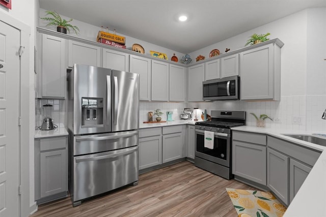 253 Centuryplant Rd, Leander, TX 78641 - kitchen with stainless steel appliances, gray cabinetry, tasteful backsplash, and recessed lighting