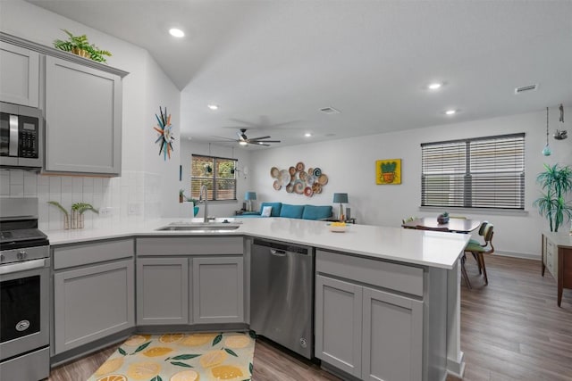 253 Centuryplant Rd, Leander, TX 78641 - kitchen with stainless steel appliances, gray cabinetry, a peninsula, ceiling fan, and recessed lighting