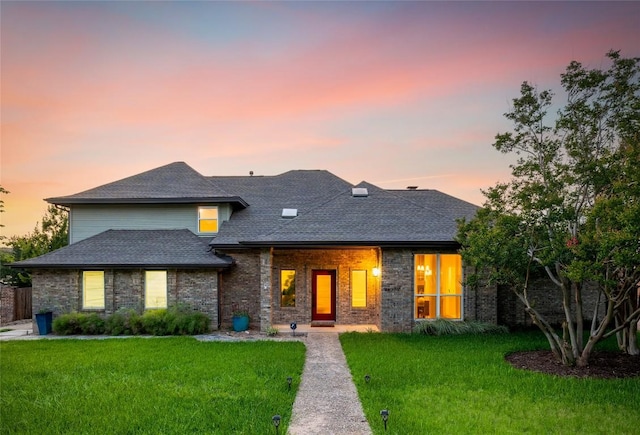 10310 Holme Lacey Ln, Austin, TX 78750 - view of front facade with a front lawn, roof with shingles, and brick siding