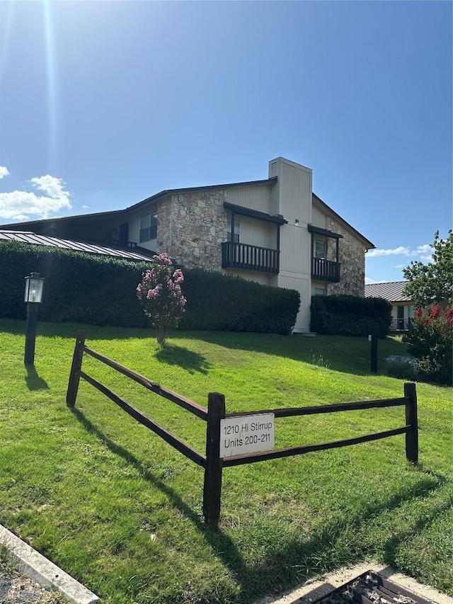 1210 Hi Stirrup Unit 201, Horseshoe Bay, TX 78657 - view of side of home with stone siding and a balcony