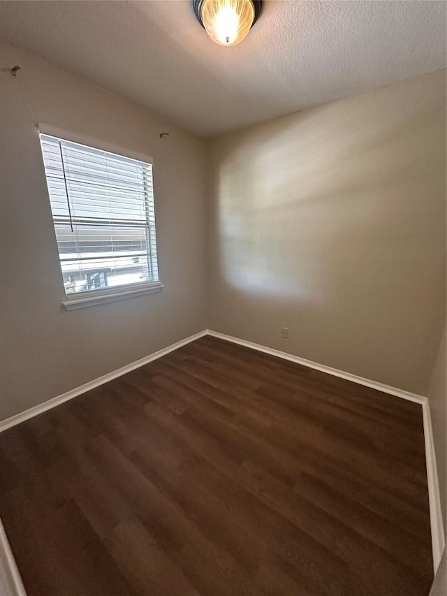 1210 Hi Stirrup Unit 201, Horseshoe Bay, TX 78657 - unfurnished room featuring dark wood-style flooring and baseboards