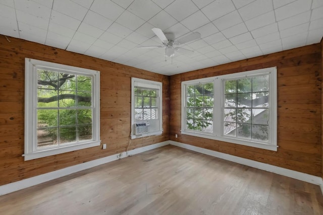 1205 Alta Vista Ave, Austin, TX 78704 - empty room with wood finished floors, ceiling fan, cooling unit, and wood walls