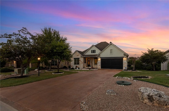 201 Glenfiddich Ln, Austin, TX 78738 - view of front of house with stone siding, concrete driveway, a front lawn, stucco siding, and an attached garage