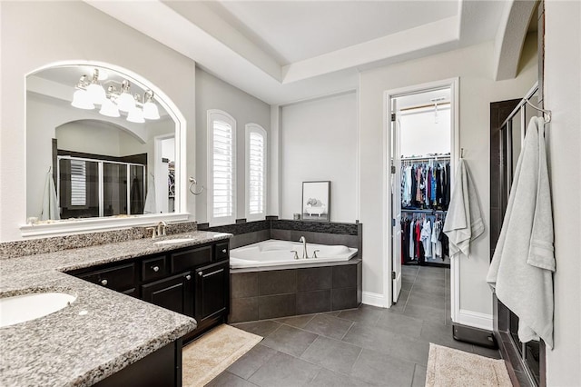 201 Glenfiddich Ln, Austin, TX 78738 - bathroom featuring vanity, a stall shower, a spacious closet, a garden tub, and a chandelier