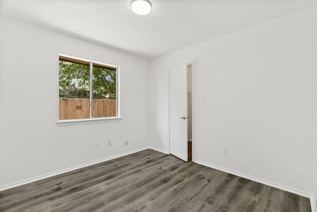 800 Saunders Dr, Round Rock, TX 78664 - empty room with dark wood-type flooring and a textured ceiling