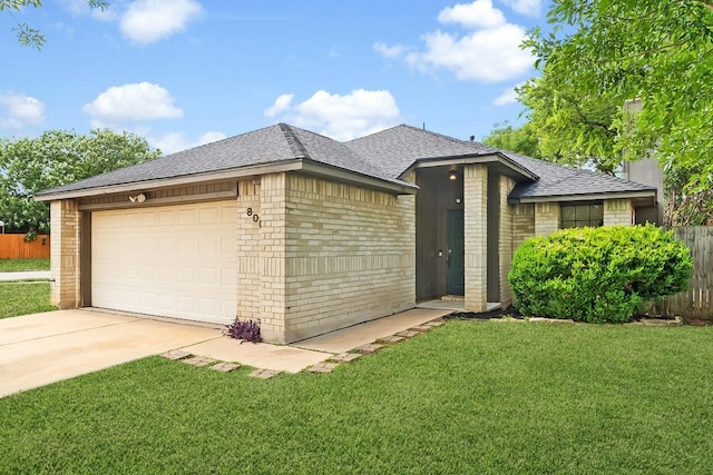 800 Saunders Dr, Round Rock, TX 78664 - view of front of home featuring brick siding, roof with shingles, concrete driveway, and an attached garage