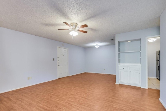 1202 Thorpe Ln Unit 407, San Marcos, TX 78666 - spare room with ceiling fan, light wood finished floors, and a textured ceiling