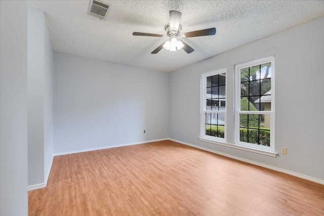 1202 Thorpe Ln Unit 407, San Marcos, TX 78666 - unfurnished room featuring wood finished floors, a textured ceiling, and a ceiling fan