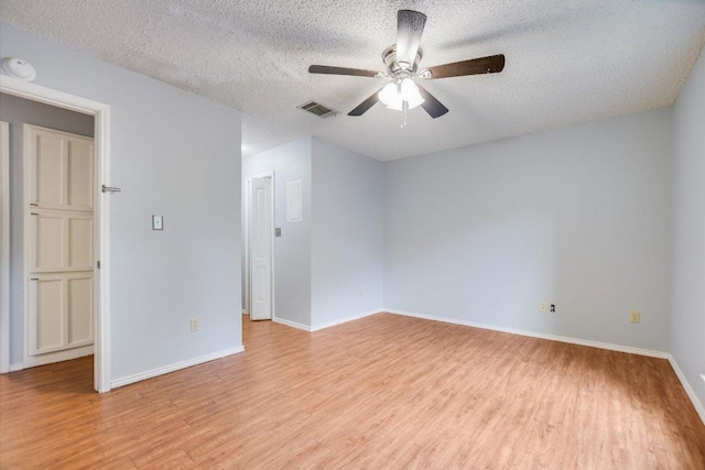 1202 Thorpe Ln Unit 407, San Marcos, TX 78666 - spare room with light wood-style floors, a ceiling fan, a textured ceiling, and a smoke detector