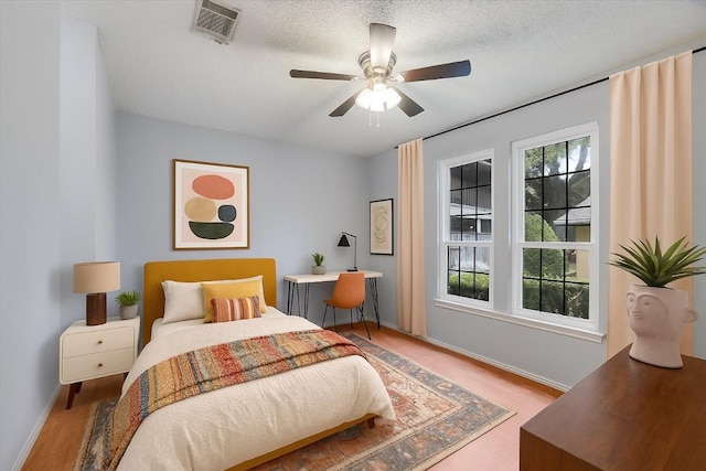 1202 Thorpe Ln Unit 407, San Marcos, TX 78666 - bedroom featuring wood finished floors and ceiling fan