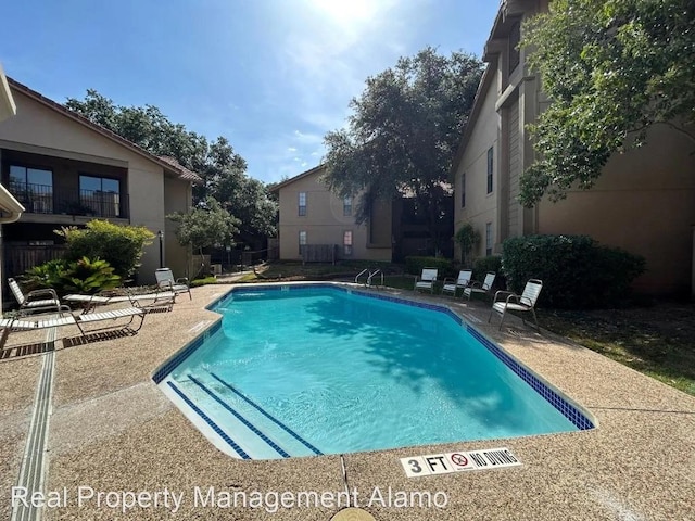 1202 Thorpe Ln Unit 407, San Marcos, TX 78666 - community pool with a patio area