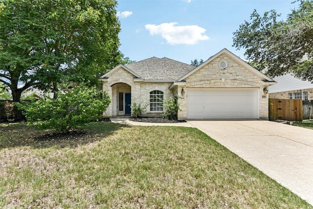 4306 S Summercrest Loop, Round Rock, TX 78681 - view of front of home with an attached garage, stone siding, driveway, and a shingled roof