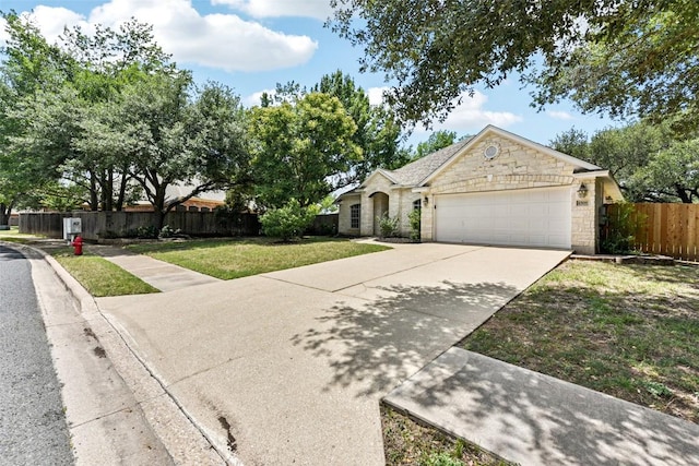4306 S Summercrest Loop, Round Rock, TX 78681 - view of front of home with stone siding, an attached garage, and driveway