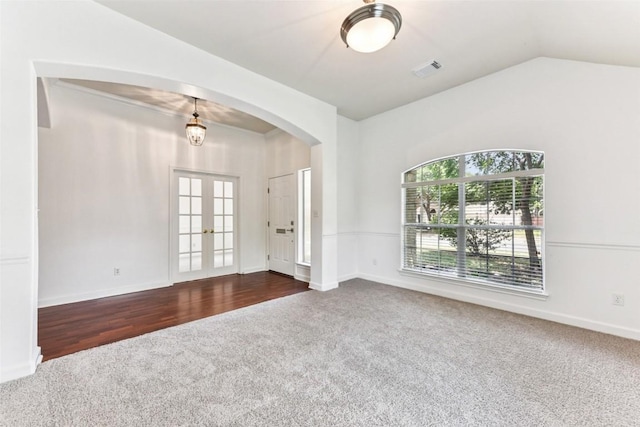 4306 S Summercrest Loop, Round Rock, TX 78681 - empty room featuring dark colored carpet, plenty of natural light, arched walkways, french doors, and lofted ceiling