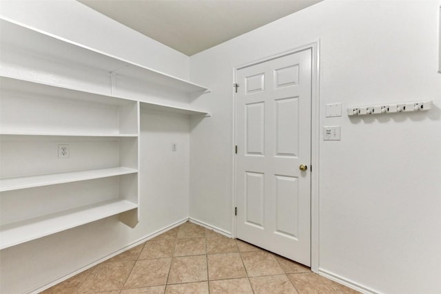 4306 S Summercrest Loop, Round Rock, TX 78681 - laundry room with light tile patterned flooring and baseboards