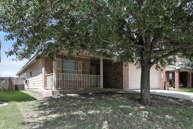 12613 Paloma Blanca Way, Del Valle, TX 78617 - view of front of house featuring covered porch, an attached garage, brick siding, and concrete driveway