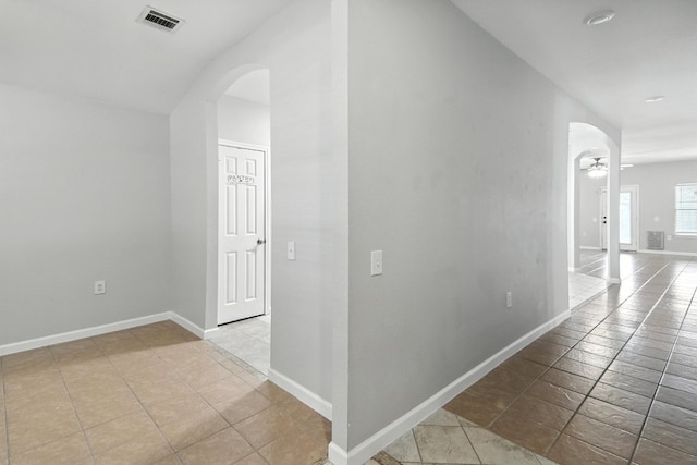 12613 Paloma Blanca Way, Del Valle, TX 78617 - hall with arched walkways, tile patterned flooring, and lofted ceiling