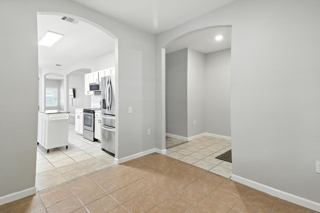 12613 Paloma Blanca Way, Del Valle, TX 78617 - hall featuring light tile patterned floors and arched walkways