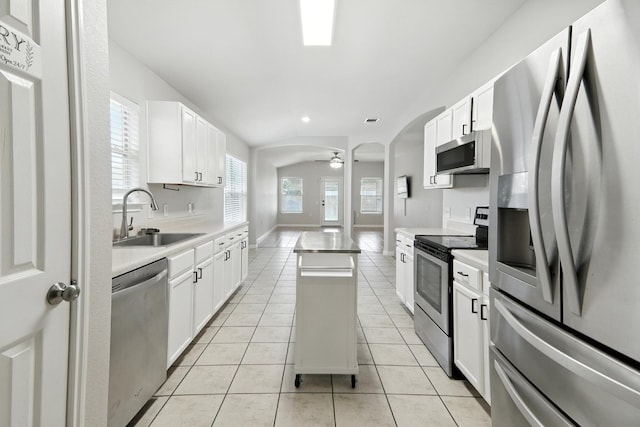 12613 Paloma Blanca Way, Del Valle, TX 78617 - kitchen with appliances with stainless steel finishes, light tile patterned floors, light countertops, ceiling fan, and recessed lighting