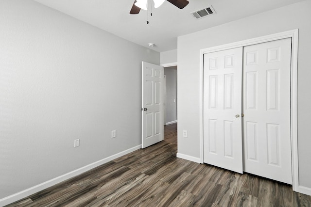 12613 Paloma Blanca Way, Del Valle, TX 78617 - unfurnished bedroom with dark wood-type flooring, a closet, and ceiling fan