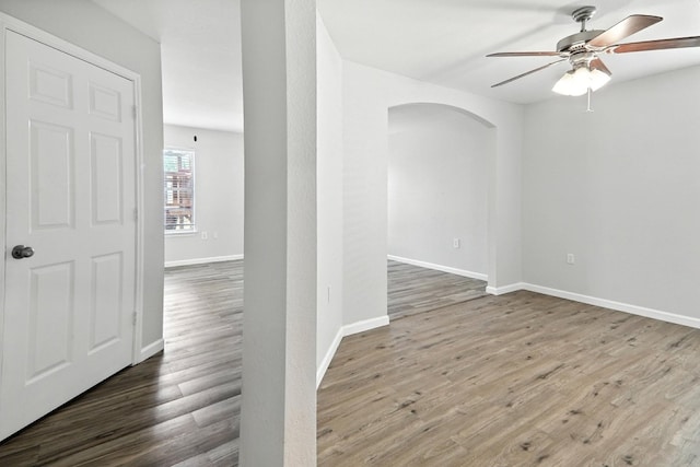 12613 Paloma Blanca Way, Del Valle, TX 78617 - unfurnished room featuring arched walkways, ceiling fan, and wood finished floors