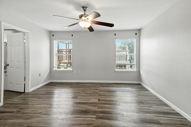 12613 Paloma Blanca Way, Del Valle, TX 78617 - empty room with a ceiling fan and dark wood-style flooring