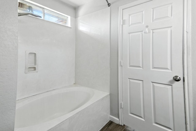 12613 Paloma Blanca Way, Del Valle, TX 78617 - bathroom with a tub to relax in and wood finished floors