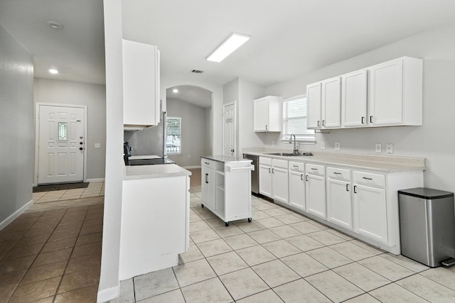 12613 Paloma Blanca Way, Del Valle, TX 78617 - kitchen featuring stove, light tile patterned floors, arched walkways, white cabinets, and recessed lighting