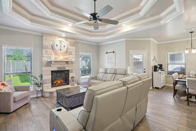 5106 La Piedra Ln, Killeen, TX 76549 - living room with a tray ceiling, ceiling fan, light wood finished floors, crown molding, and a fireplace