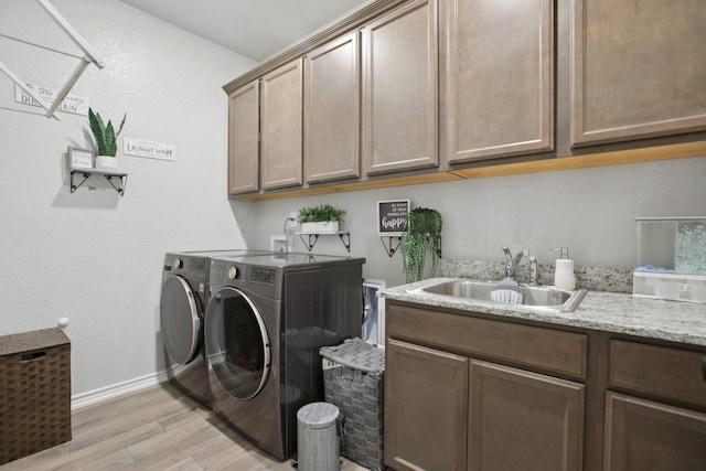 5106 La Piedra Ln, Killeen, TX 76549 - washroom featuring separate washer and dryer, light wood-style floors, and cabinet space